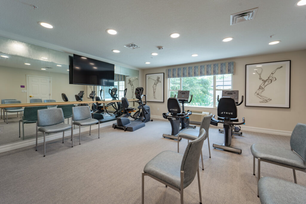 MemC 32 of 52 - Ambiance at Maitland Modern fitness center with cardio equipment and seating area promotes wellness for assisted living residents near Longwood FL.