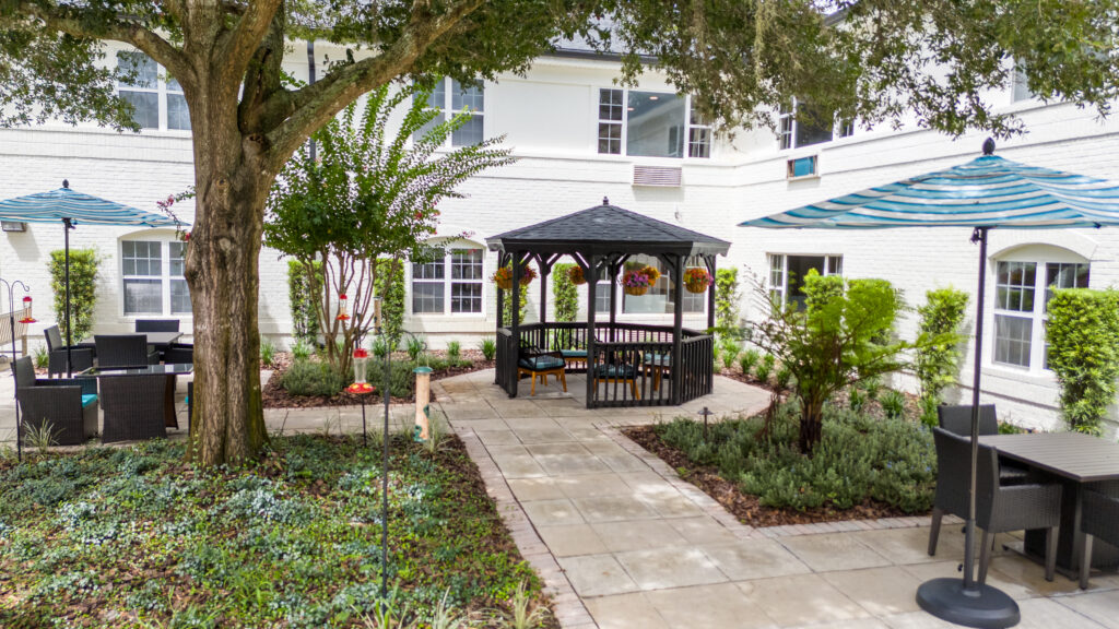 default - Ambiance at Maitland Serene outdoor courtyard with wooden gazebo and stone pathways at Ambiance at Maitland, offering senior living near Apopka.